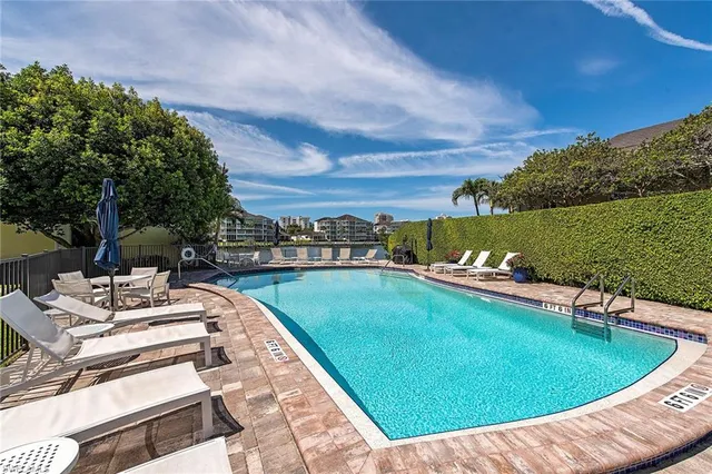 a view of a swimming pool and lounge chairs on th terrace