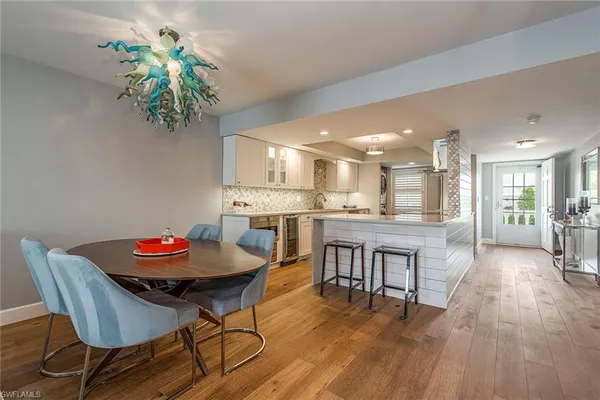 a dining room with furniture and wooden floor
