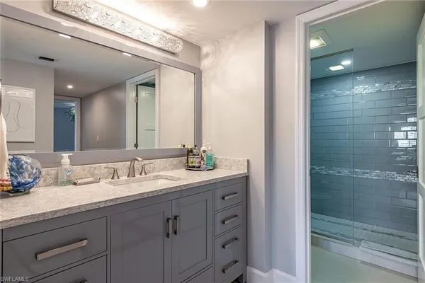 a bathroom with a double vanity sink and mirror