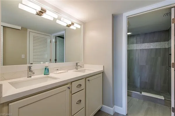 a bathroom with a double vanity sink and mirror
