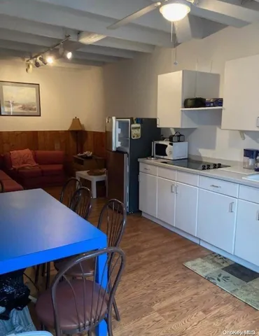 a kitchen with a stove a table and chairs in it