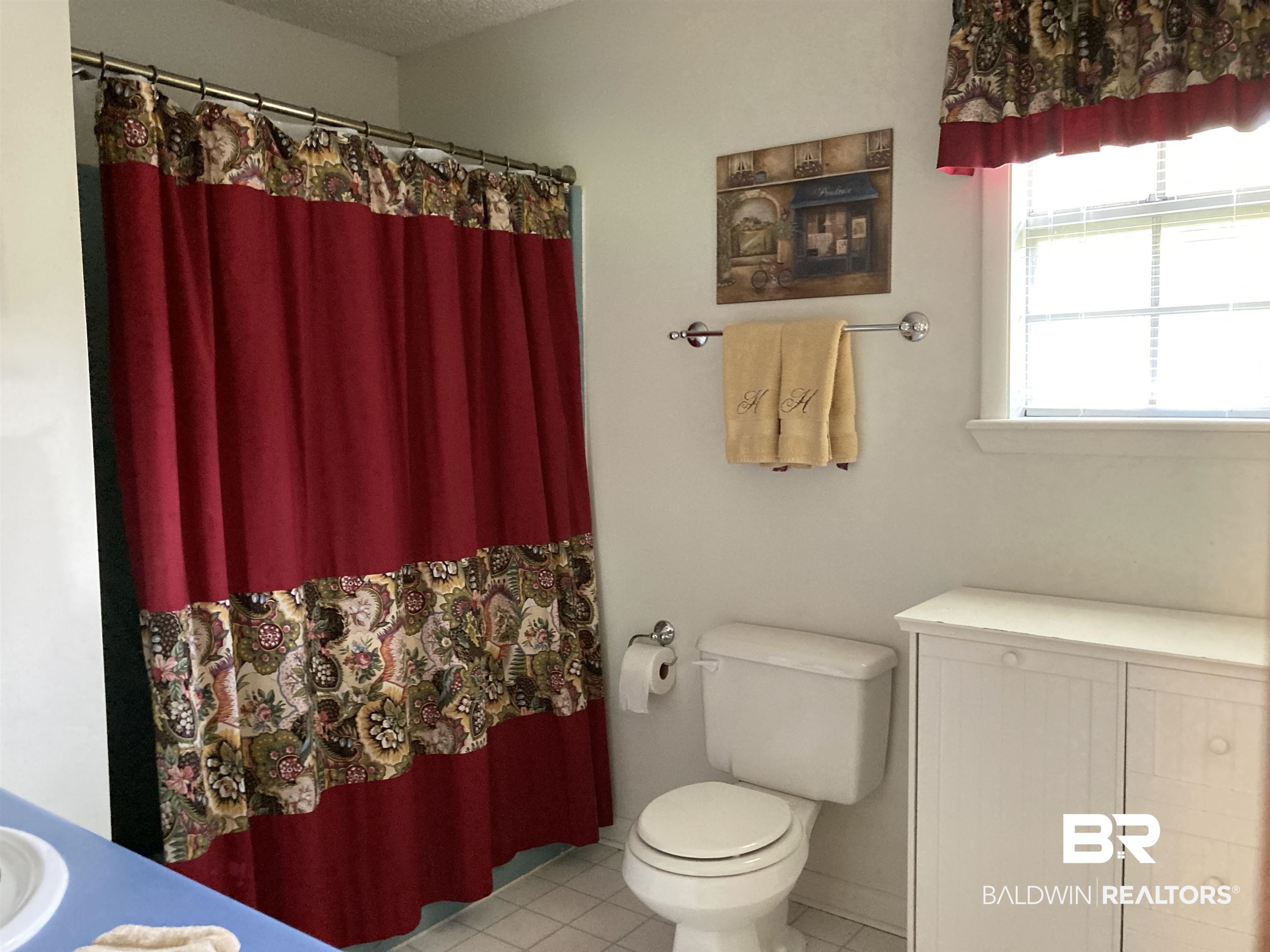 6151 Meadows Road Walnut Hill, FL 32568 - Photo 21 of 29 Bathroom with a shower with curtain, tile patterned flooring, a textured ceiling, toilet, and vanity