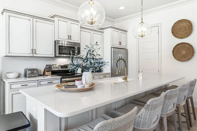 a kitchen with kitchen island white cabinets and stove