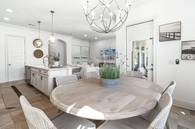 a balcony with couple of chairs and a potted plant