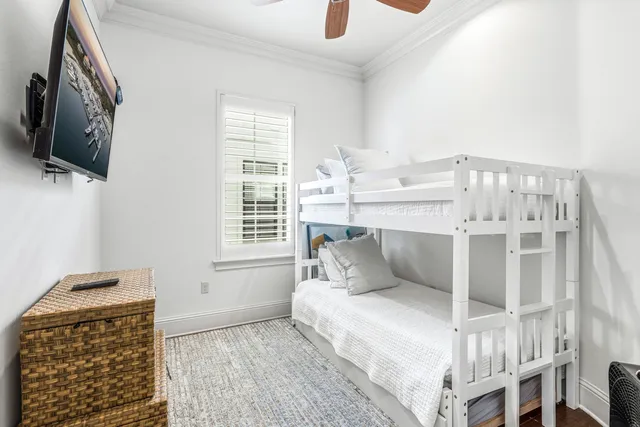 a spacious bedroom with a bed and a chandelier