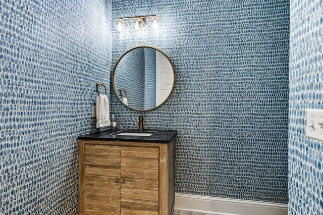 a bathroom with a sink a toilet and a mirror