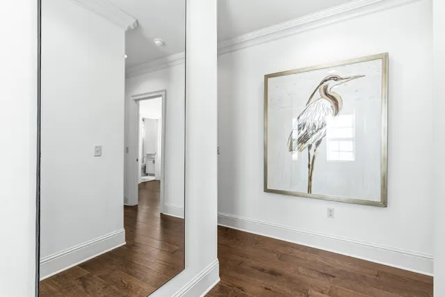 a bedroom with a bed a flat screen tv and a window