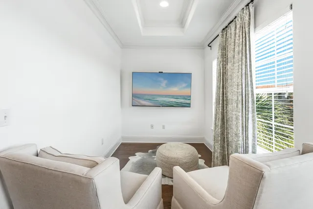 a front view of a house with plants and a tree