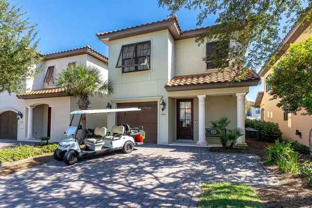 a view of a house with a garden and patio