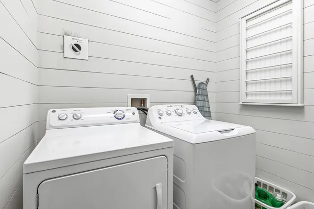 an aerial view of a house with a garden and lake view