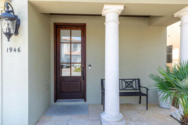 a view of entryway with paintings on the wall