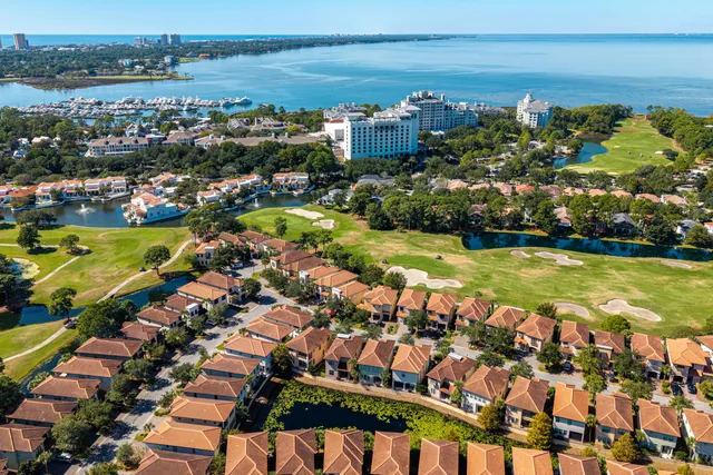 a view of a big yard with table and chairs under an umbrella