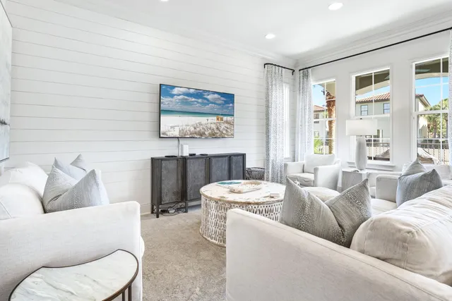 a living room with furniture and a wall painting