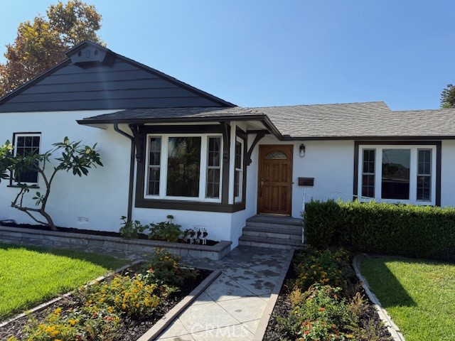 7964 Comolette Street Downey, CA 90242 - Photo 1 of 22 a front view of a house with garden