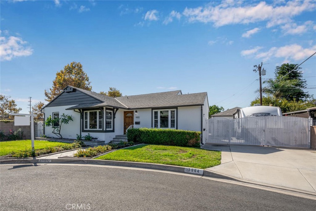 7964 Comolette Street Downey, CA 90242 - Photo 12 of 22 a front view of a house with a garden and yard