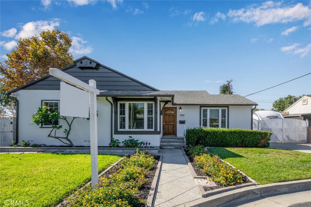 7964 Comolette Street Downey, CA 90242 - Photo 14 of 22 a front view of a house with garden
