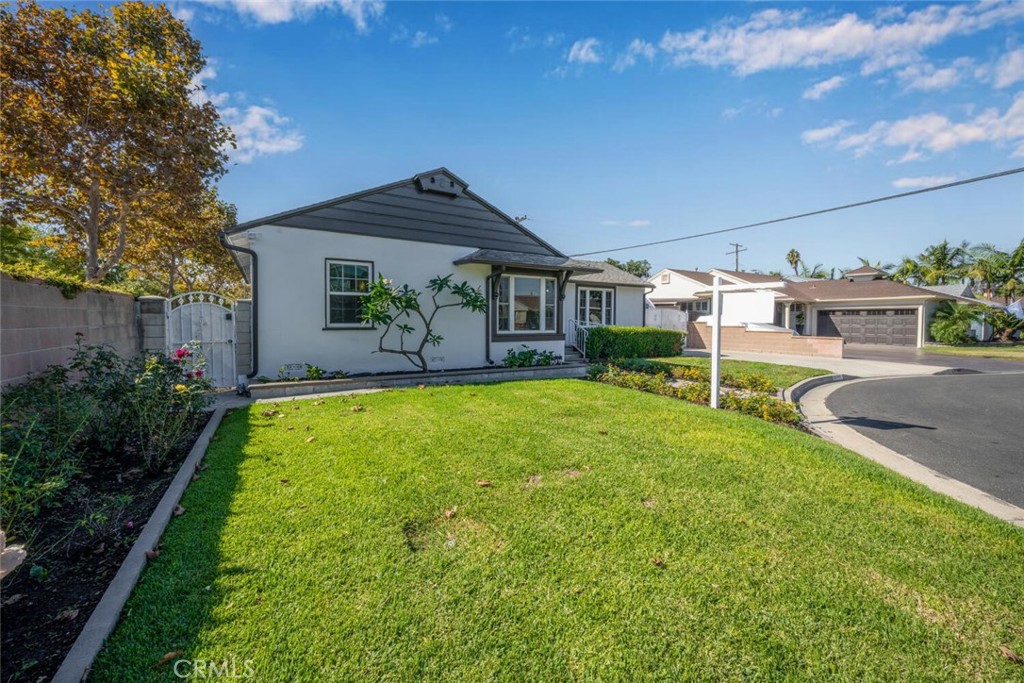 7964 Comolette Street Downey, CA 90242 - Photo 19 of 22 a front view of house with yard and outdoor seating