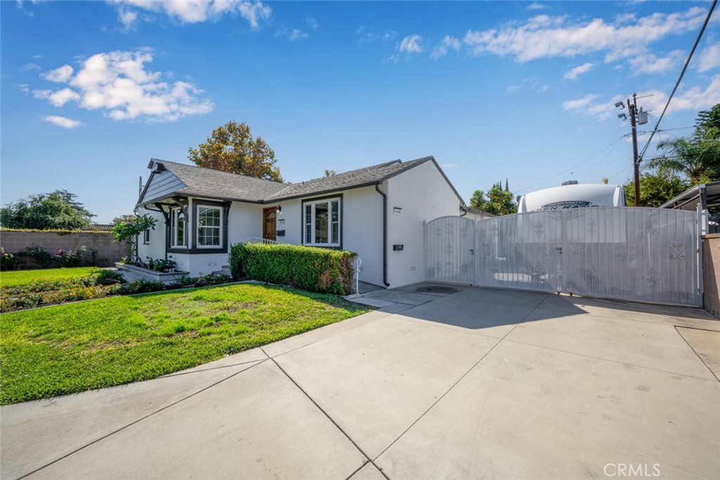 7964 Comolette Street Downey, CA 90242 - Photo 21 of 22 a front view of a house with garden