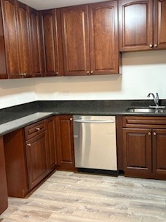 22 A Kingery Quarter, Unit 202 Willowbrook, IL 60527 - Photo 2 of 14 a kitchen with granite countertop wooden cabinets