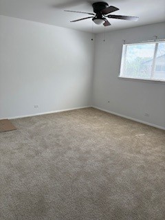 22 A Kingery Quarter, Unit 202 Willowbrook, IL 60527 - Photo 8 of 14 an empty room with a chandelier fan