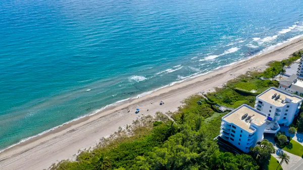 a balcony with beautiful flowers and wooden fence