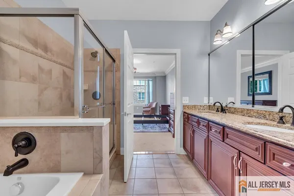 a spacious bathroom with a granite countertop sink and a mirror
