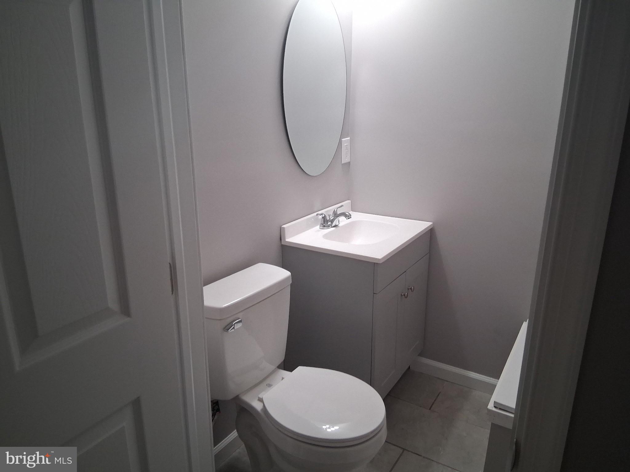 7 May Avenue New Castle, DE 19720 - Photo 16 of 21 a bathroom with a toilet a sink and mirror