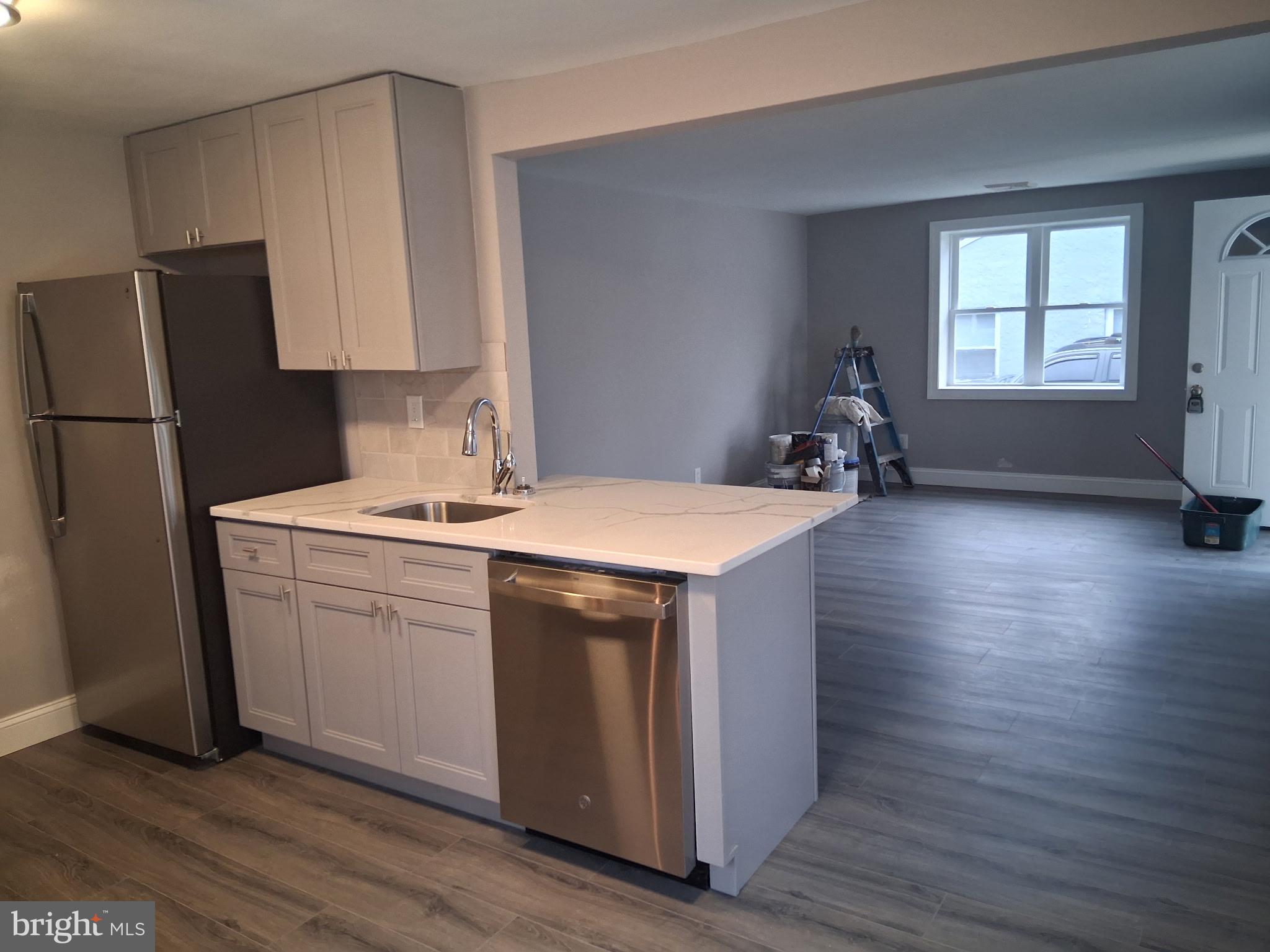 7 May Avenue New Castle, DE 19720 - Photo 9 of 21 a kitchen with sink cabinets and wooden floor