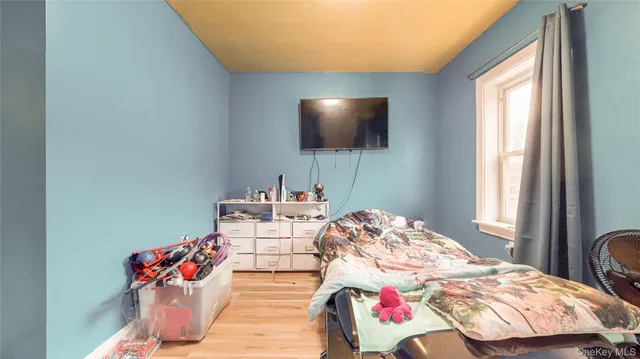 a bedroom with furniture and a flat screen tv