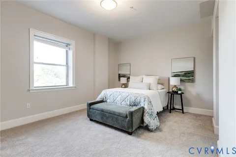 a spacious bedroom with a bed and a window