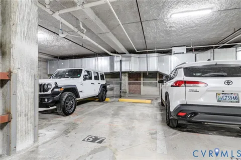 a view of parking garage with cars parked