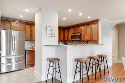 a kitchen with stainless steel appliances granite countertop a refrigerator and microwave