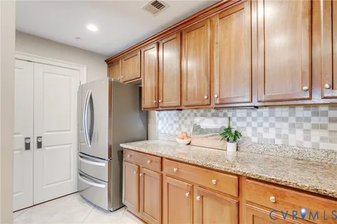 a kitchen with stainless steel appliances granite countertop a refrigerator and a sink