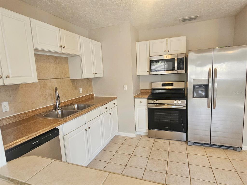 7000 Brentford Road Sarasota, FL 34241 - Photo 14 of 29 a kitchen with cabinets stainless steel appliances and a counter space