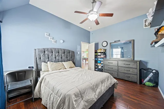 a bedroom with a bed a dresser and chair