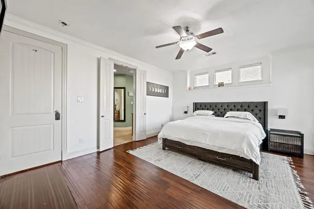 a bedroom with a bed and a ceiling fan
