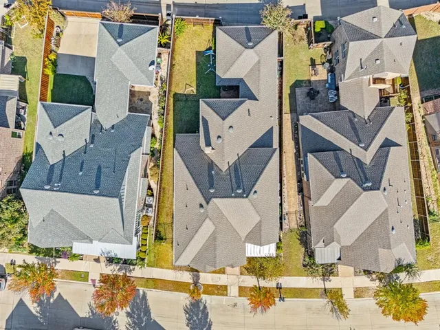 an aerial view of residential houses with outdoor space