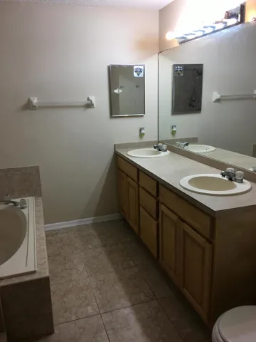 a bathroom with a double vanity sink and mirror