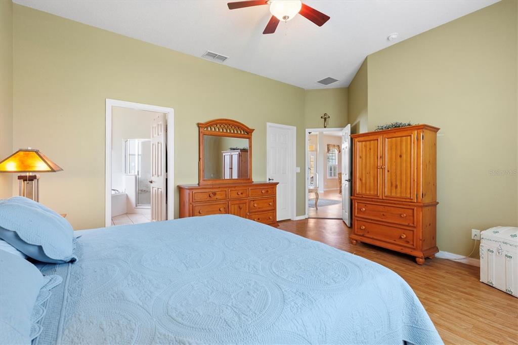 17739 Southeast 121st Terrace Road Summerfield, FL 34491 - Photo 15 of 48 a bedroom with a bed and wooden floor