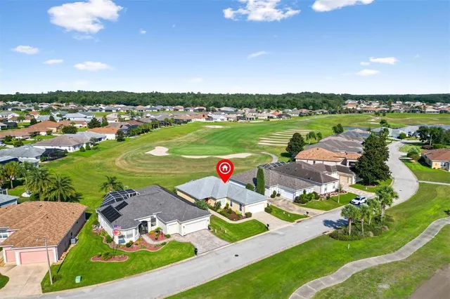 an aerial view of a house with a big yard