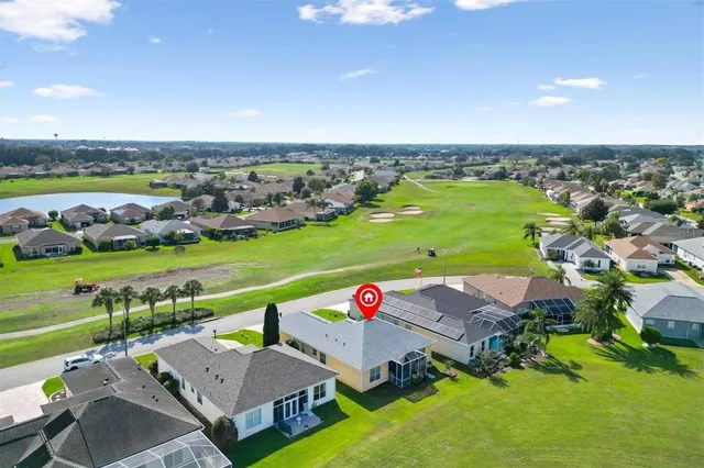 an aerial view of a house with a swimming pool yard and outdoor seating