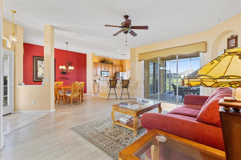 17739 Southeast 121st Terrace Road Summerfield, FL 34491 - Photo 5 of 48 a living room with furniture a ceiling fan and a rug