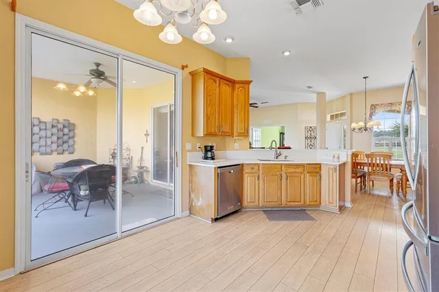 a kitchen with stainless steel appliances a refrigerator and a stove top oven