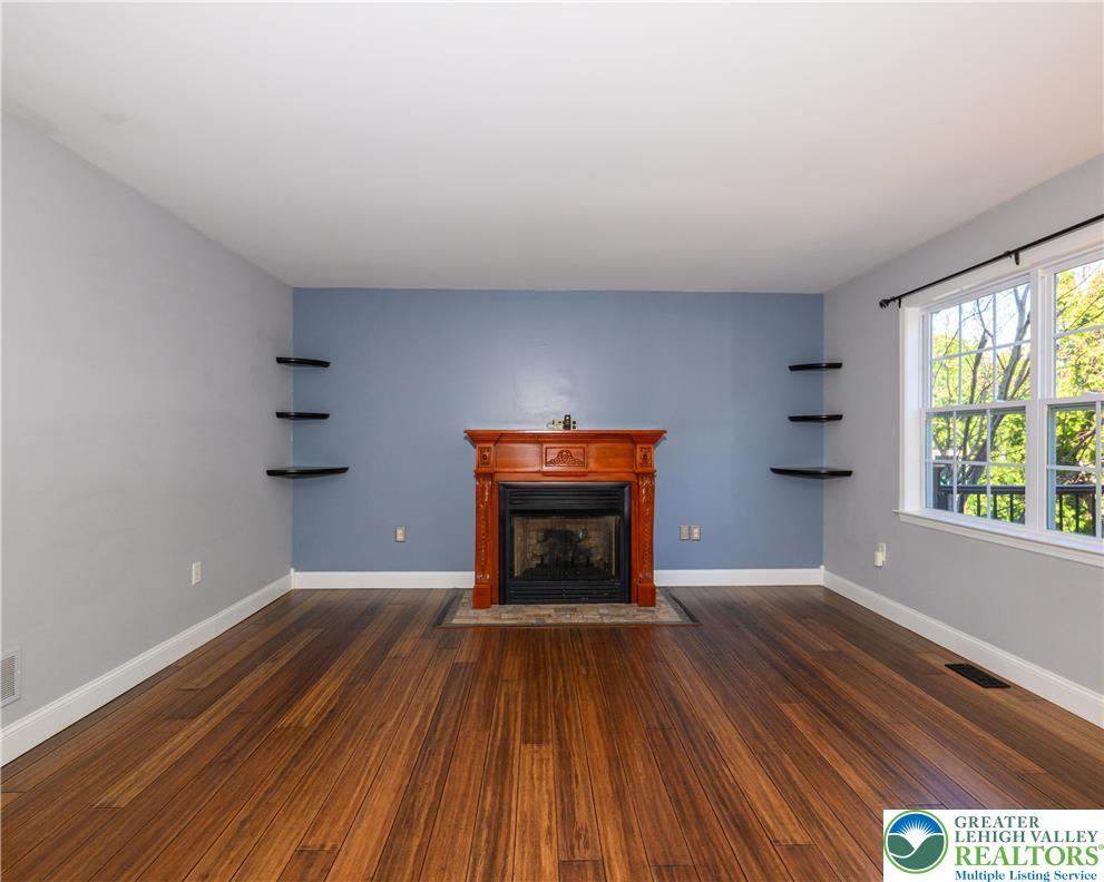 1252 Center Street Coplay, PA 18037 - Photo 14 of 63 a view of empty room with wooden floor and fireplace