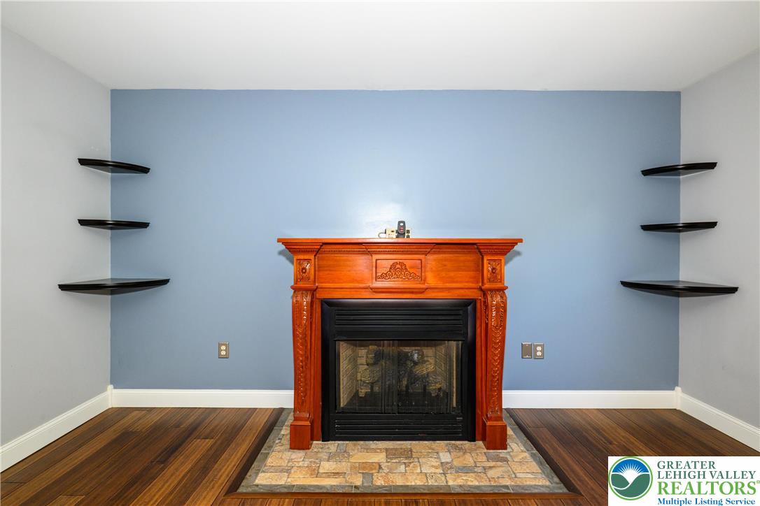 1252 Center Street Coplay, PA 18037 - Photo 16 of 63 a room with fireplace and a wooden floor