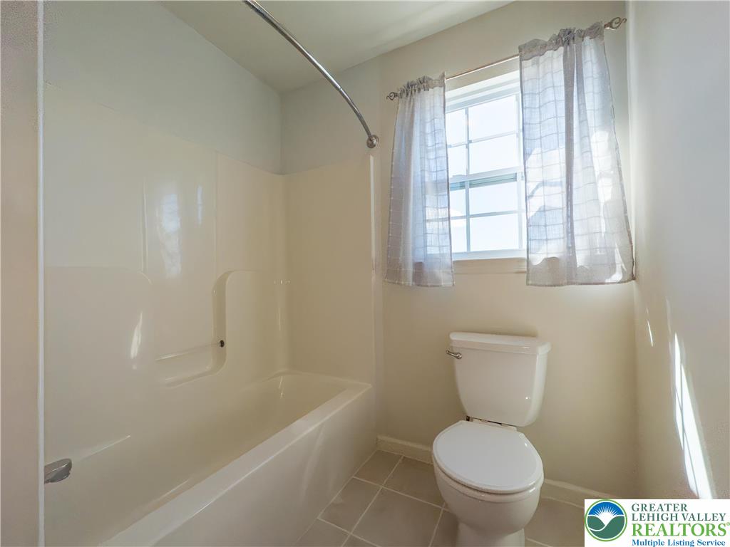 1252 Center Street Coplay, PA 18037 - Photo 26 of 63 a white toilet sitting next to a bath tub