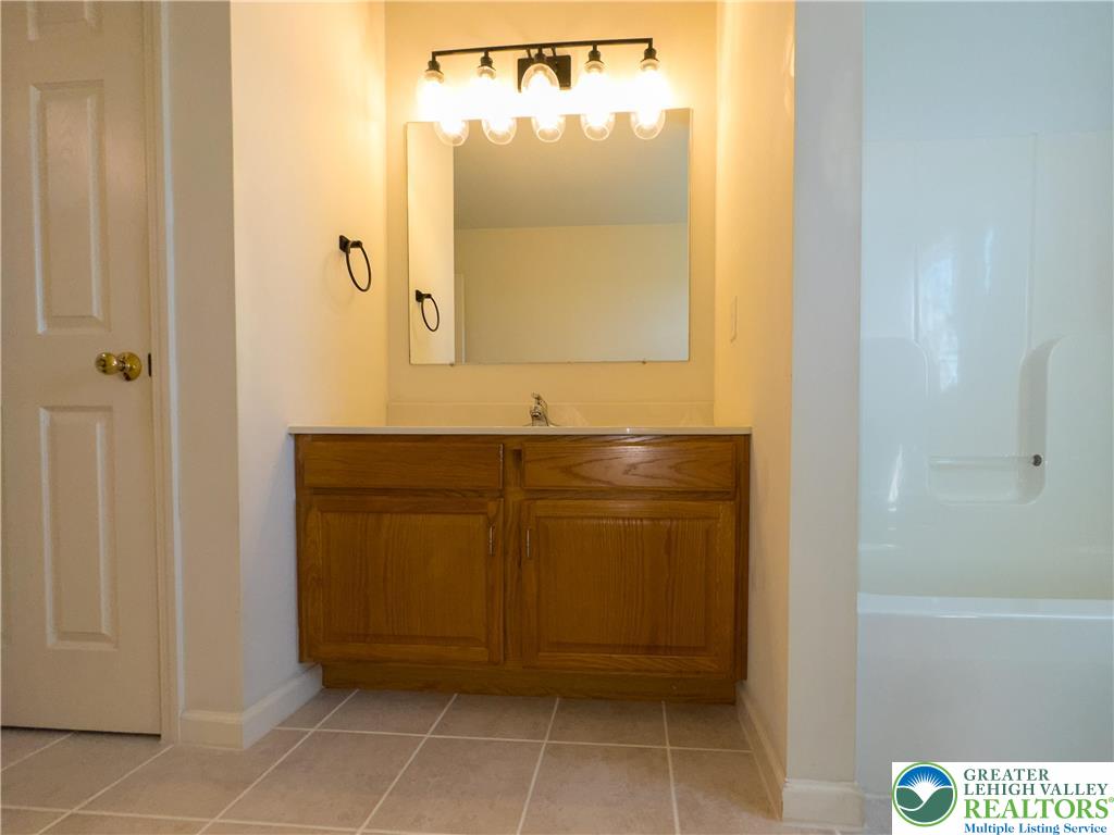 1252 Center Street Coplay, PA 18037 - Photo 27 of 63 a bathroom with a granite countertop sink a mirror and a shower