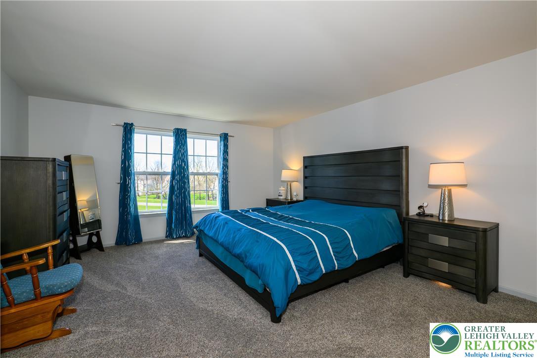 1252 Center Street Coplay, PA 18037 - Photo 30 of 63 a bedroom with a bed flat screen tv and window