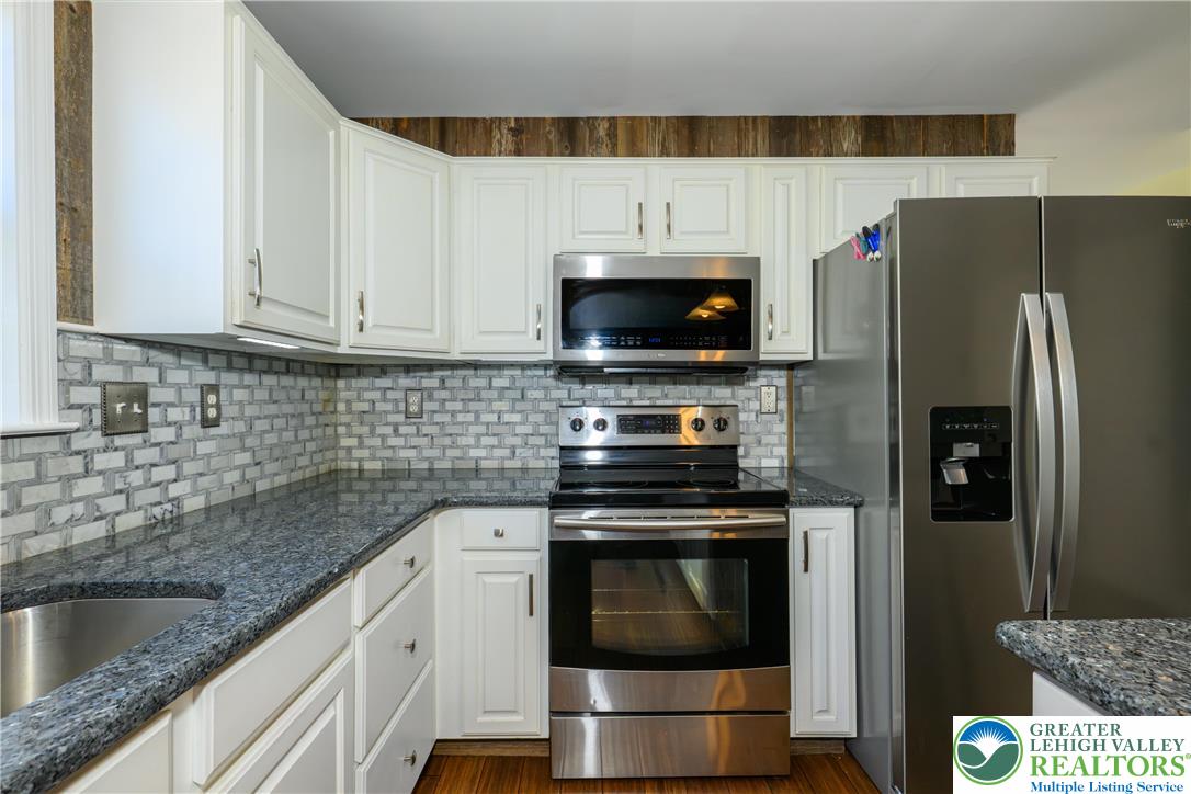 1252 Center Street Coplay, PA 18037 - Photo 4 of 63 a kitchen with stainless steel appliances a stove a sink and a microwave