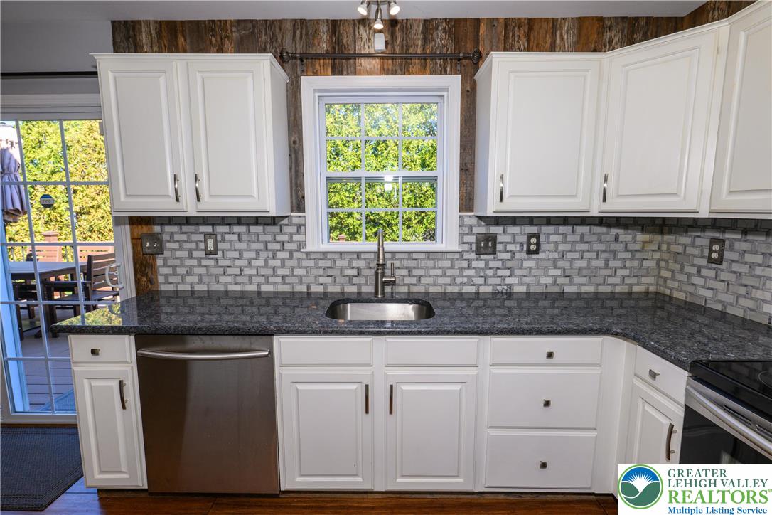 1252 Center Street Coplay, PA 18037 - Photo 5 of 63 a kitchen with granite countertop white cabinets and white appliances